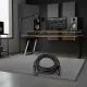 Câble XLR mâle-femelle BSN enroulé sur un tapis dans un studio d'enregistrement moderne avec équipement audio professionnel.